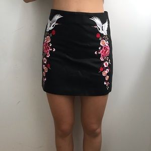 Pleather skirt with floral detailing.